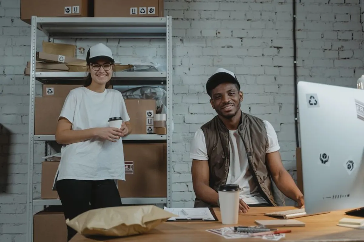 Two people at a shipping desk, smiling